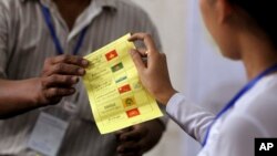 Officials of Union Election Commission count ballots at a polling station in Yangon, Myanmar, April 1, 2017. 