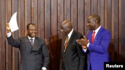 Guillaume Soro holds a document after being re-elected as the president of the National Assembly in Abidjan, Ivory Coast, Jan. 9, 2017.