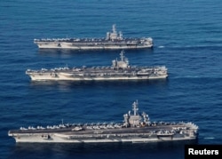 FILE PHOTO - The aircraft carriers USS Ronald Reagan (CVN 76), USS Theodore Roosevelt (CVN 71) and USS Nimitz (CVN 68) are underway, conducting operations, in international waters as part of a three-carrier strike force exercise in western Pacific, Novemb