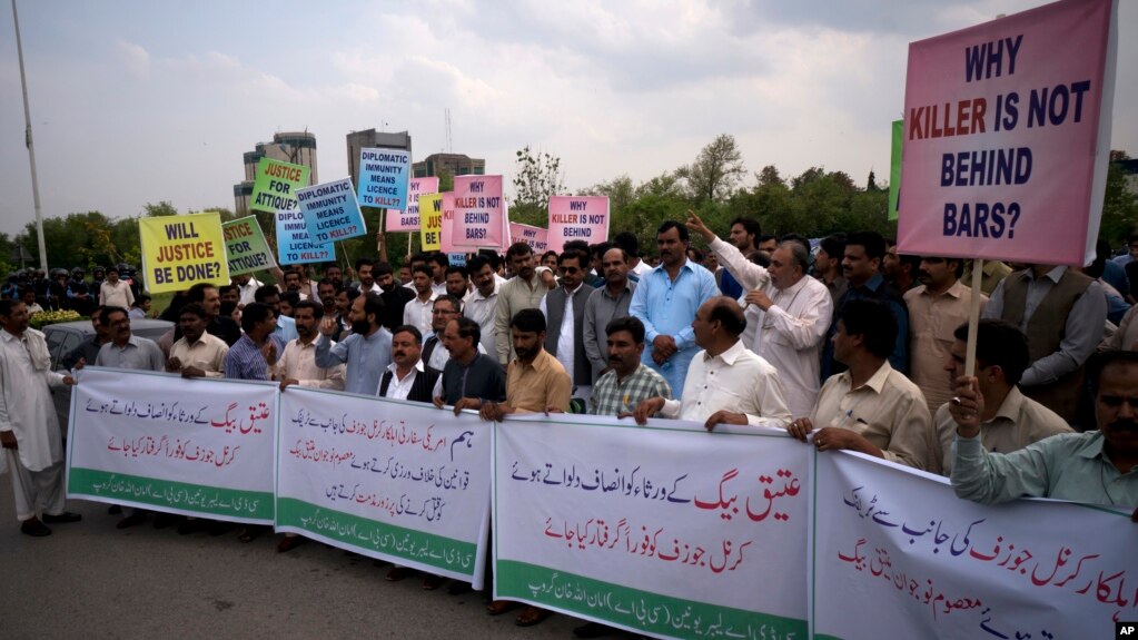 FILE - Pakistani protesters demand a trial for American diplomat involved in a vehicle crash that killed a person, in Islamabad, April 10, 2018. In a second accident involving a U.S. diplomat, which occurred April 29, 2018, Pakistani authorities have charged a U.S. Embassy security officer with trying to obstruct an investigation.
