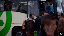 Palestinians laborers board a Palestinian-only bus on route to the West Bank after working in Tel Aviv, March 4, 2013.