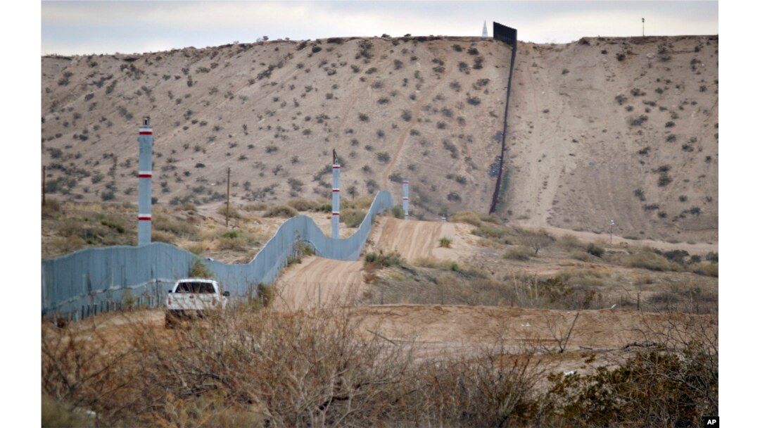 FILE - A U.S. Border Patrol agent drives near the U.S.-Mexico border fence in Sunland Park, N.M. The building of a border wall was one of the main tenets of the Donald Trump campaign.