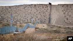 FILE - A U.S. Border Patrol vehicle drives near the U.S.-Mexico border fence in Sunland Park, New Mexico. The contruction of a border wall was among Donald Trump's major talking points during the campaign.