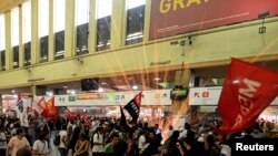 A firework explodes as members of the "Free Pass" movement invade the Central Train Station to demand zero tariffs in the Brazilian public transport system in Rio de Janeiro, Feb.6, 2014.