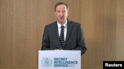 FILE - Britain's MI6 chief Alex Younger speaks at MI6's Vauxhall Cross headquarters in central London, Britain, in this still image from video, Dec. 8, 2016.