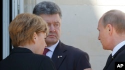 German Chancellor Angela Merkel, left, Russian President Vladimir Putin, right, and Ukrainian president-elect Petro Poroshenko, center, talk after a group photo, June 6, 2014.