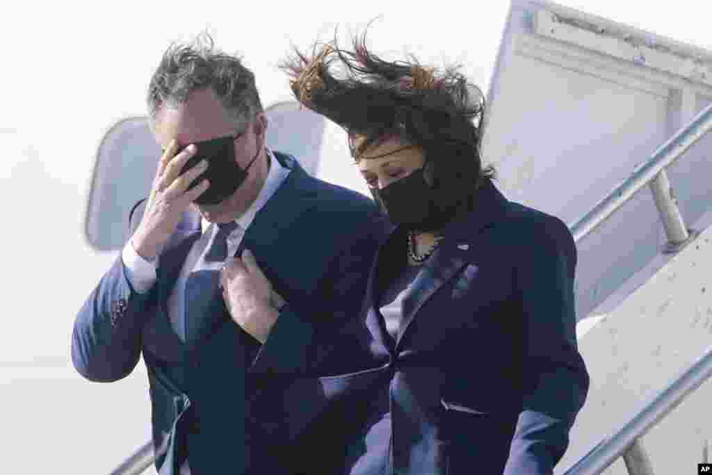 Vice President Kamala Harris and her husband Doug Emhoff, walk off Air Force Two on arrival to Los Angeles, March 15, 2021.