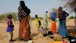 FILE - Chadians who fled the Lake Chad shore village of N'Gouboua stand in their makeshift camp 20 kms (14 miles) from N'Gouboua, Chad, March 5, 2015.