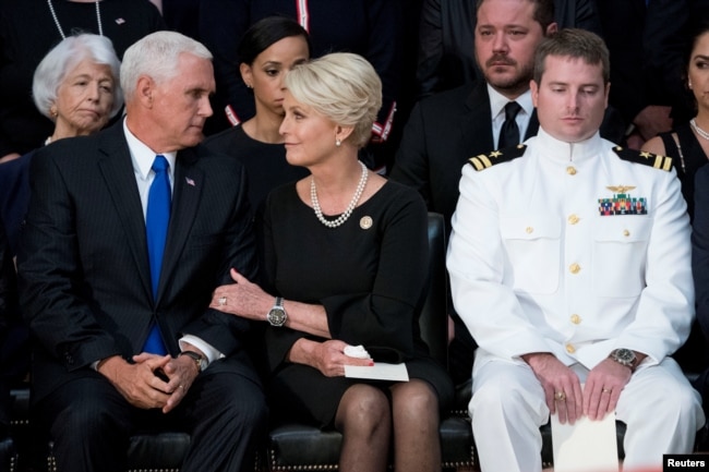 Cindy McCain, wife of late Sen. John McCain, center, talks with Vice President Mike Pence, left, after he spoke at a ceremony for John McCain in the Rotunda of the U.S. Capitol, Aug. 31, 2018, in Washington.