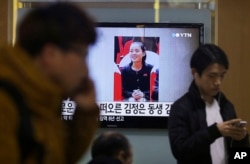 FILE - A TV news program shows Kim Yo Jong, North Korean leader Kim Jong Un's younger sister, at Seoul Railway Station in Seoul, South Korea, Nov. 27, 2014. North Korea has revealed that Kim is a senior official in the ruling Workers' Party.