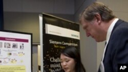 Top 2011 winner Angela Zhang with Eric Spiegel, CEO of Siemens Corporation.