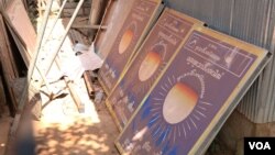 Signs advertising the opposition Cambodia National Rescue Party lie in the dirt at the Chantrey commune police office after being taken down when the party was dissolved in November last year. Feb. 15, 2018 (Sun Narin/VOA Khmer)