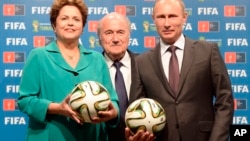 FILE – From left, Brazilian President Dilma Rousseff and FIFA chief Sepp Blatter hand over World Cup hosting duties to Russian leader Vladimir Putin after the 2014 final match in Rio de Janeiro, July 13, 2014. 