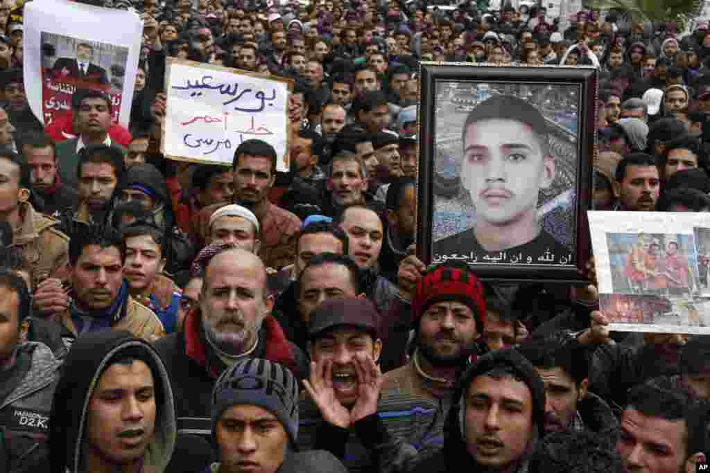 Protesters chant slogans and hold a picture of a slain young man in Port Said, Egypt, Feb. 1, 2013. 