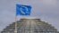 The European Union flag is seen above the cupola of the Reichstag building, the seat of the Bundestag in Berlin, April 2, 2012. 