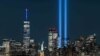 The Statue of Liberty shines near the Tribute in Light as part of the commemoration for 20th anniversary of the terrorist attack in New York City, Sept. 11, 2021.