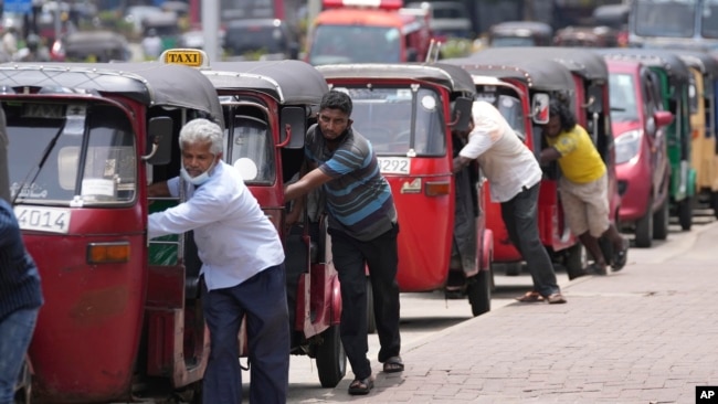 FILE- Sri Lankan drivers line up to buy fuel near a fuel station in Colombo, Sri Lanka on April 13, 2022. (AP Photo/Eranga Jayawardena, File)