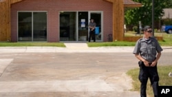 Security personnel stand outside a recently opened Planned Parenthood clinic, Sept. 10, 2024, in Pittsburg, Kan.