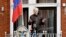 FILE - WikiLeaks founder Julian Assange gestures as he speaks on the balcony of the Ecuadorian embassy, in London, May 19, 2017. 