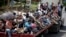 Honduran migrants who are traveling to the United States as a group, get a free ride in the back of a trailer truck flatbed, as they make their way through Teculutan, Guatemala, Oct. 17, 2018.