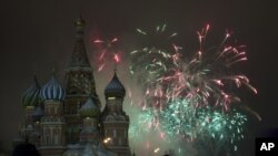 Former French first ladies Carla Bruni-Sarkozy (left) and Valerie Trierweiler (right) stand with politicians and entertainment artists holding a banner that reads "Leaders, bring back our girls" during a demonstration near the Eiffel Tower in Paris, May 13, 2014.