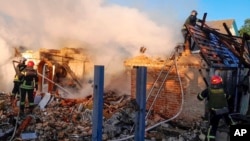 In this photo provided by the Ukrainian Emergency Service, rescuers work at a damaged building after a Russian missile attack in Kyiv region, Ukraine, May 8, 2024. 