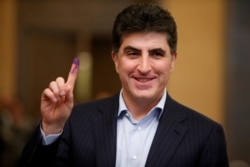 FILE PHOTO: Nechirvan Barzani shows his ink-stained finger after casting his vote at a polling station during the parliamentary election.