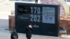 A man stands in front of a countdown clock for Tokyo Olympic and Paralympic Games in Tokyo, Wednesday, Feb. 3, 2021. Pressure is building on Japanese organizers and the IOC to explain exactly how they plan to hold the Tokyo Olympics in the midst of…