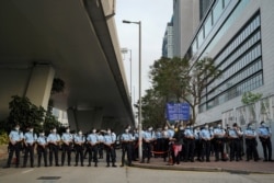Police officers outside West Kowloon Magistrates' Courts in Hong Kong, March 1, 2021.