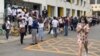People wearing protective face masks to help curb the spread of the new coronavirus line up outside a health checkup center to get a nucleic acid test in Beijing, Monday, June 15, 2020. China's capital was bracing Monday for a resurgence of the…