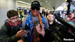 FILE - Former NBA basketball player Dennis Rodman talks to the media at the Beijing International Airport.