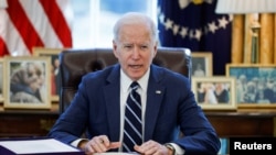 FILE - President Joe Biden signs the American Rescue Plan, a package of economic relief measures to respond to the impact of the coronavirus disease (COVID-19) pandemic, inside the Oval Office at the White House in Washington, March 11, 2021.