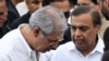 Mukesh Ambani (R), Chairman and Managing Director of Reliance Industries, speaks with Noel Tata, Chairman of Trent and Tata Investment Corporation, after paying his last respect to Ratan Tata ahead of its cremation in Mumbai, Oct. 10, 2024. 