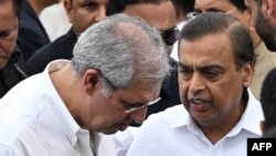 Mukesh Ambani (R), Chairman and Managing Director of Reliance Industries, speaks with Noel Tata, Chairman of Trent and Tata Investment Corporation, after paying his last respect to Ratan Tata ahead of its cremation in Mumbai, Oct. 10, 2024. 