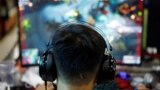 A man plays online game on a computer at an internet cafe in Beijing, China August 31, 2021. (REUTERS/Florence Lo)