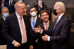 FILE - U.S President Joe Biden (R) speaks with Turkey's President Recep Tayyip Erdogan prior to a plenary session of a NATO summit at NATO headquarters in Brussels, June 14, 2021. (Photo by Olivier Matthys / Pool / AFP)