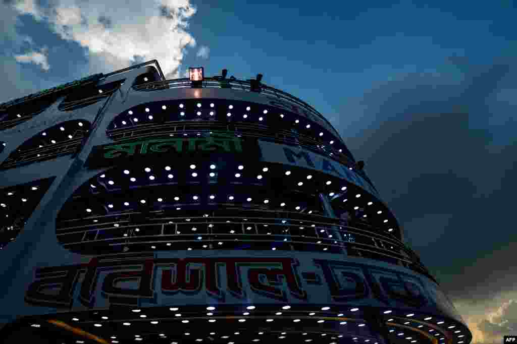 Passengers travel back to their villages to celebrate Eid-al-Adha festival, at Sadarghat launch terminal in Dhaka, Bangladesh.