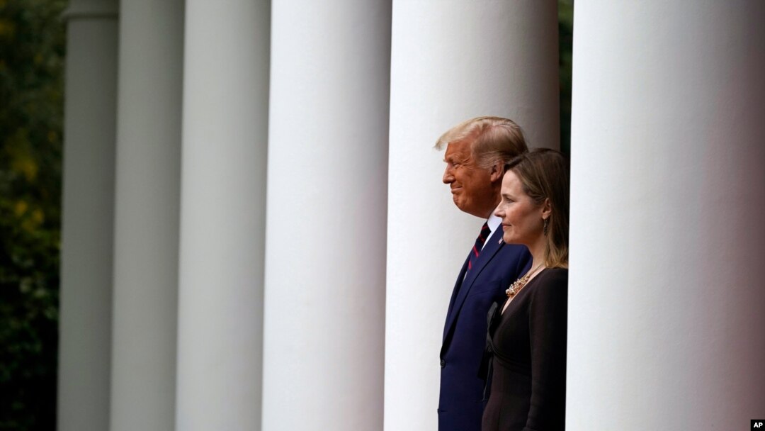 Presiden Donald Trump berjalan bersama Hakim Amy Coney Barrett untuk menghadiri konferensi pers untuk mengumumkan nominasi Barrett sebagai Hakim Mahkamah Agung, di Rose Garden, Gedung Putih, Washington, Sabtu, 26 September 2020.(Foto: AP)
