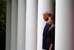 President Donald Trump walks with Judge Amy Coney Barrett to a news conference to announce Barrett as his nominee to the Supreme Court, in the Rose Garden at the White House, Sept. 26, 2020, in Washington.