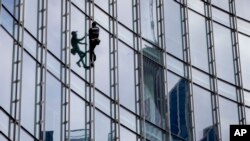 French urban climber Alain Robert climbs up the Skyper highrise in Frankfurt, Germany, Sept. 28, 2019.