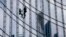 French urban climber Alain Robert climbs up the Skyper highrise in Frankfurt, Germany, Sept. 28, 2019.
