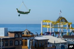 FILE - A view of the famous pier and amusement park in Santa Monica, California on March 9, 2023. (AP Photo/Jae C. Hong)