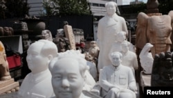 FILE - Busts and statues portraying late Chinese chairman Mao Zedong are seen at the Panjiayuan flea market in Beijing, May 19, 2019.