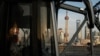 FILE - A bus moves past a bridge with the backdrop of the financial district of Pudong in Shanghai, China, Sept. 27, 2024