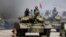 FILE - Soldiers in tanks are paraded across Kim Il Sung Square during a military parade, April 15, 2017, in Pyongyang, North Korea. The United Nations is investigating at least seven African countries accused of receiving military assistance from North Ko