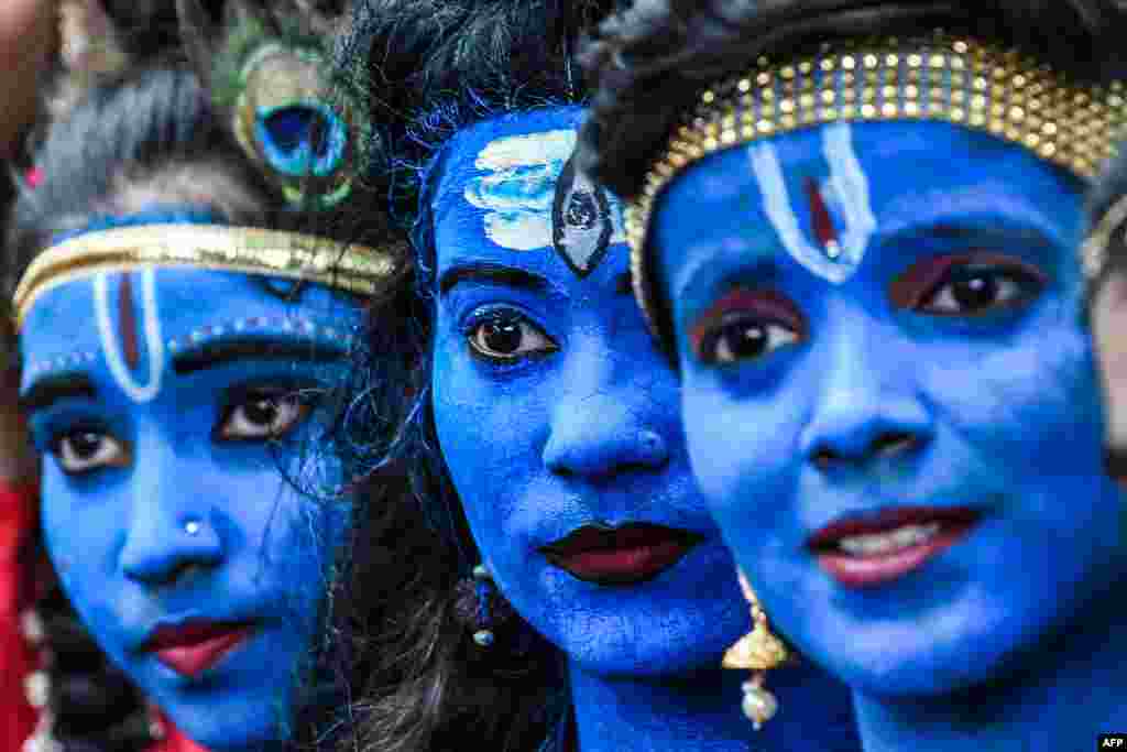 Students dressed as Hindu gods Lord Krishna and Lord Shiva participate in a cultural event at their school in Mumbai, India.