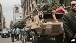 FILE - Soldiers guard a street near a church in downtown Cairo, Egypt, April 10, 2017, following Palm Sunday bombings in churches in Tanta and Alexandria that killed 45 Coptic Christians.