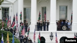 U.S. President Joe Biden, Kenyan President William Ruto, U.S. first lady Jill Biden and Kenyan first lady Rachel Ruto stand at the balcony of a building during an official White House State Arrival ceremony at the White House in Washington, U.S., May 23, 2024.