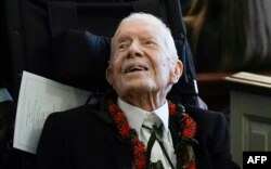 FILE - Former President Jimmy Carter departs after the funeral service for former first lady Rosalynn Carter at Maranatha Baptist Church, in Plains, Georgia, on November 29, 2023.