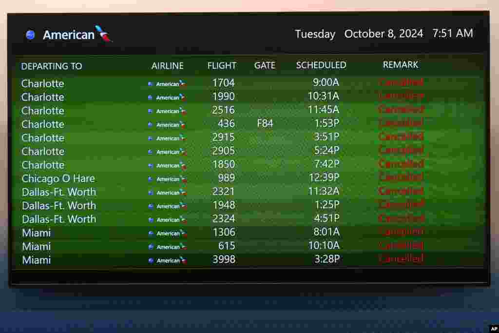 A message board at the Tampa International Airport shows all American Airlines departing flight canceled, Oct. 8, 2024, in Tampa, Florida, due to the possible arrival of Hurricane Milton.